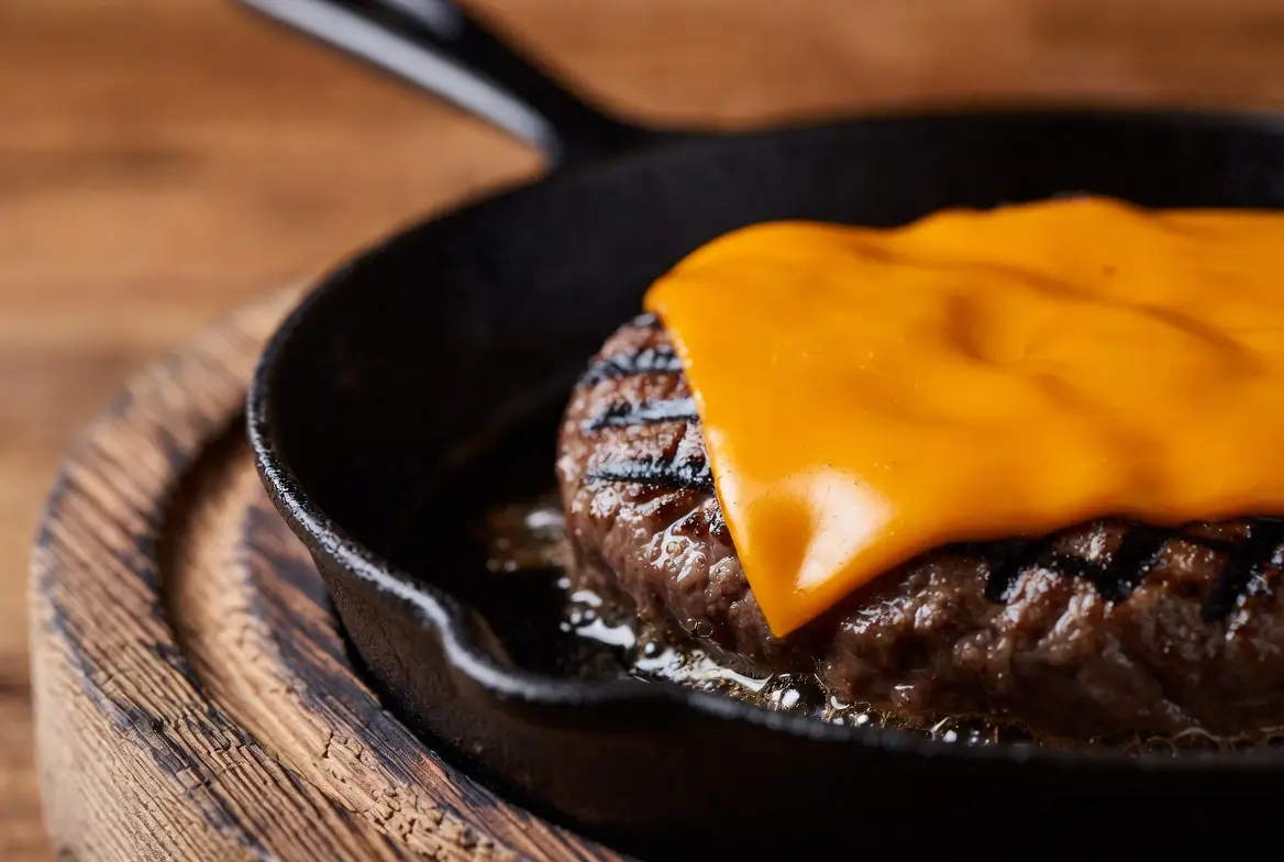 Illustrative bunless beef burger with salad